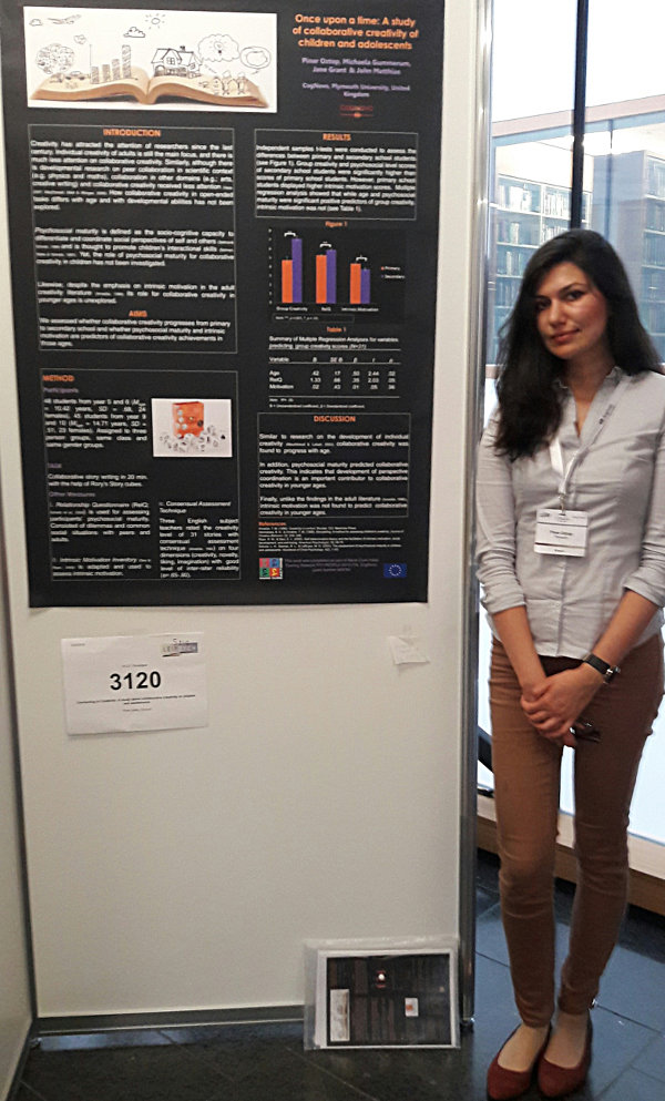 Pinar Oztop in front of her poster